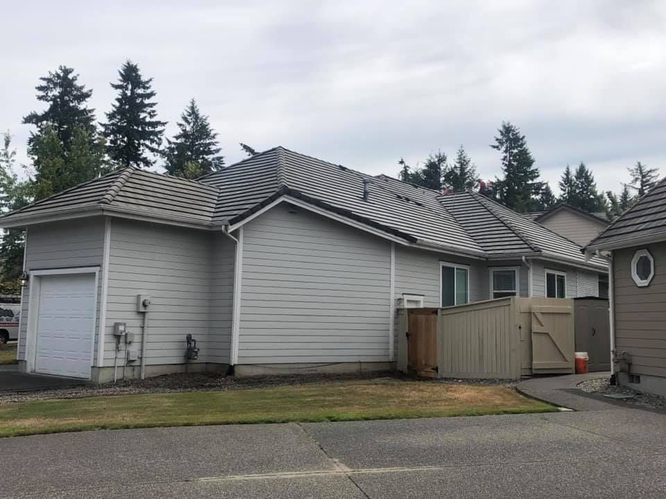 A house with a garage and a fence in front of it