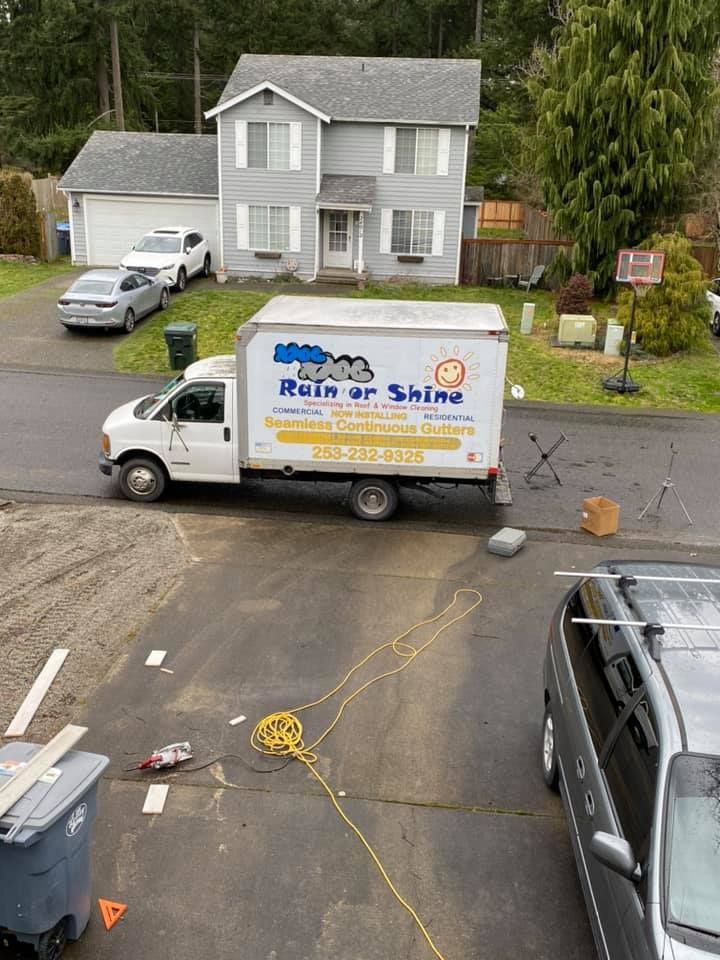 A white truck is parked in front of a house.