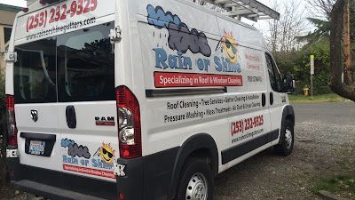 A white van is parked on the side of the road.