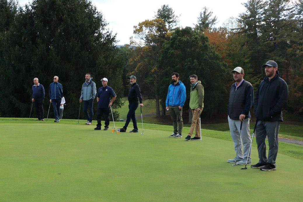 A group of men are standing on a golf course holding golf clubs. Reems Creek Golf Club. Weaverville, North Carolina.