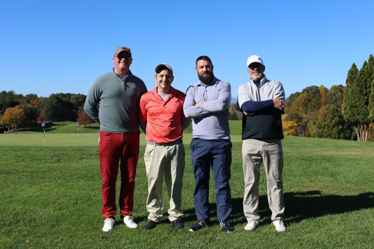 A group of men are posing for a picture on a golf course. Reems Creek Golf Club. Weaverville, North Carolina.