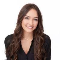 Man wearing glasses, looking to the side, wearing a gray shirt and lanyard.