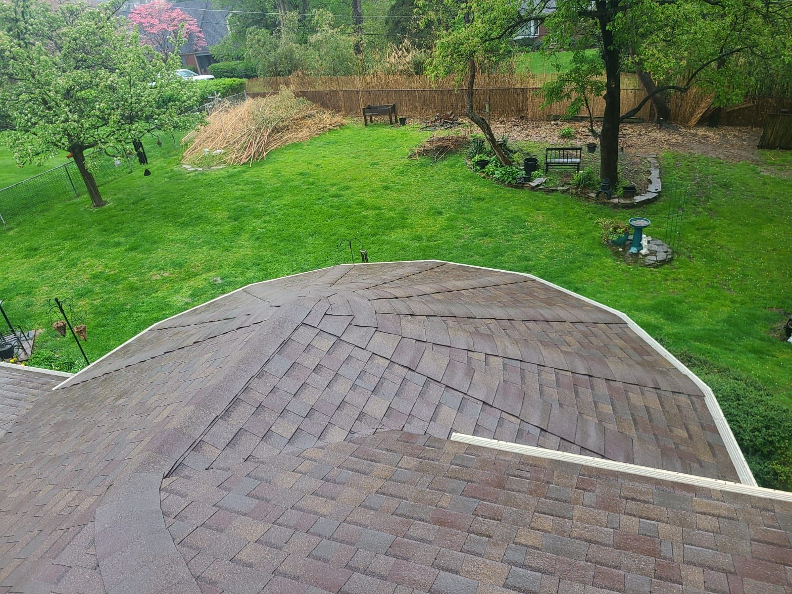 House with roofing under construction; tar paper and shingles are visible on the roof.