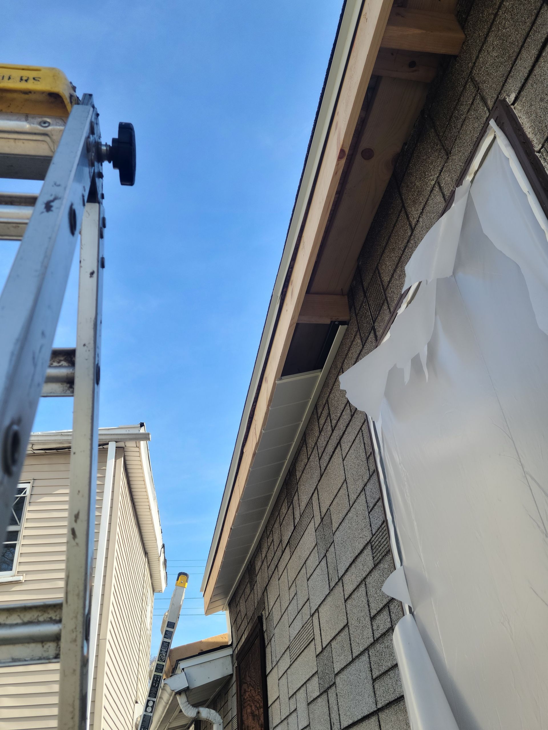 A front porch with a fire pit, red door, and rocking chairs.