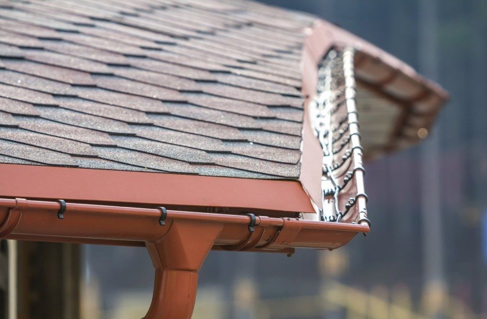 Brown roof with matching gutters and downspout.