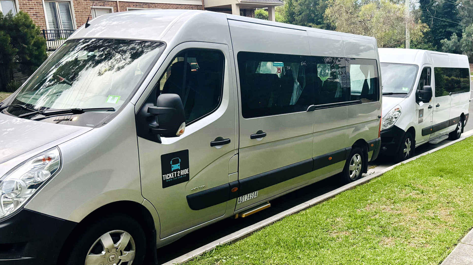 A photo of the two Ticket 2 Ride minibuses parked behind each other