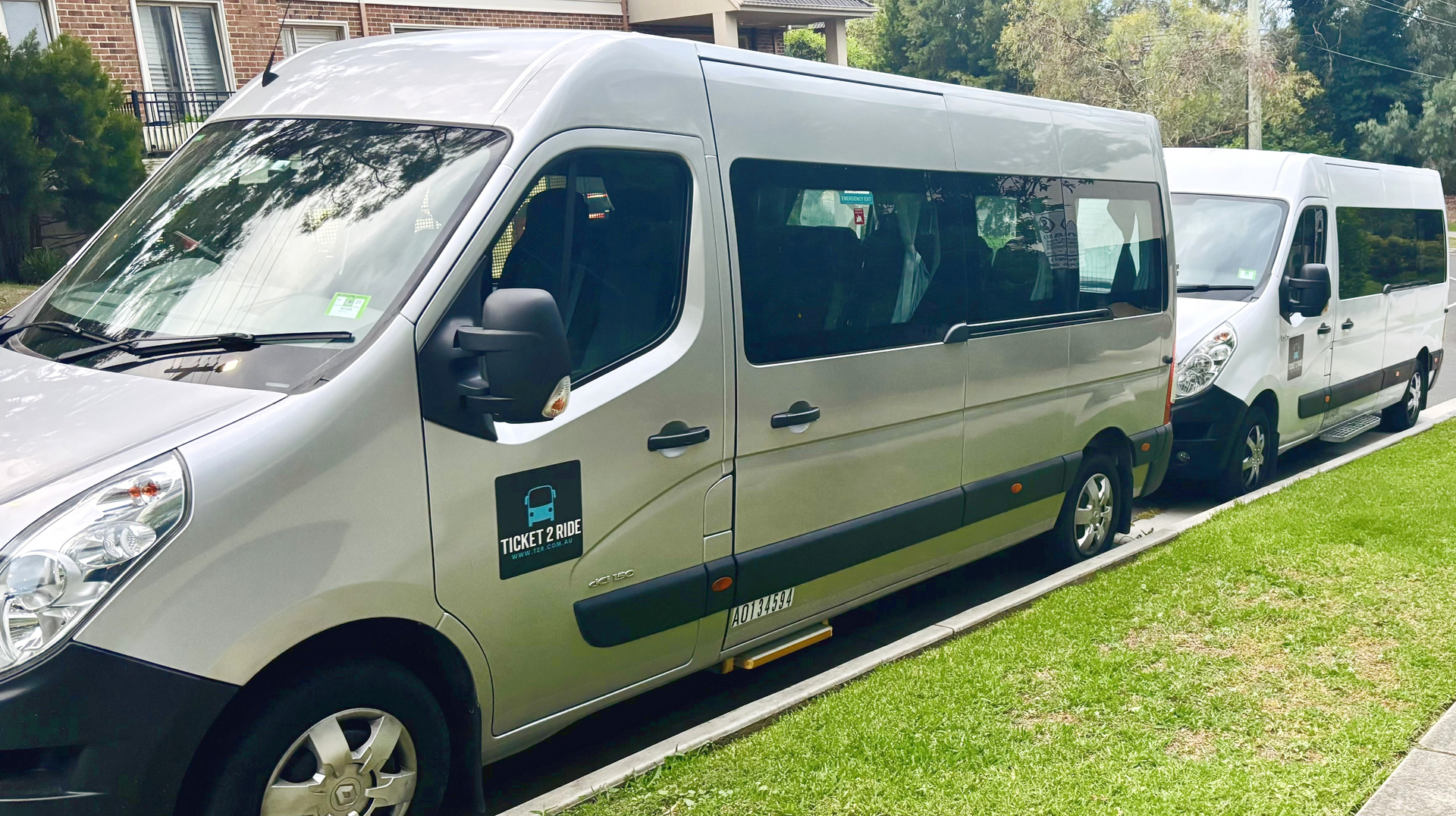 Two Ticket 2 Ride minibuses parked. One behind the other.