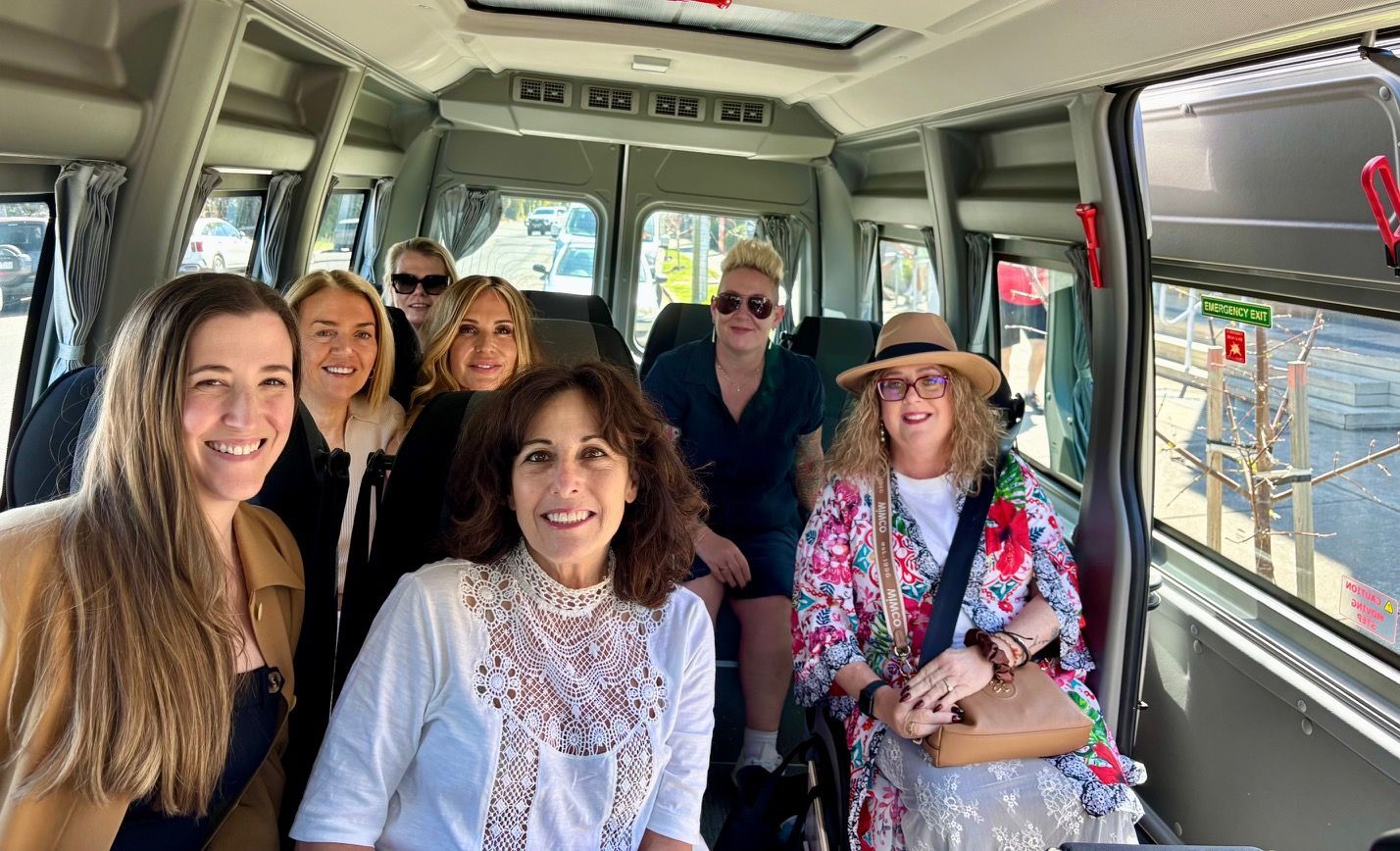 A group of guests standing in front of the Ticket 2 Ride minibus while on a Yarra Valley winery tour.