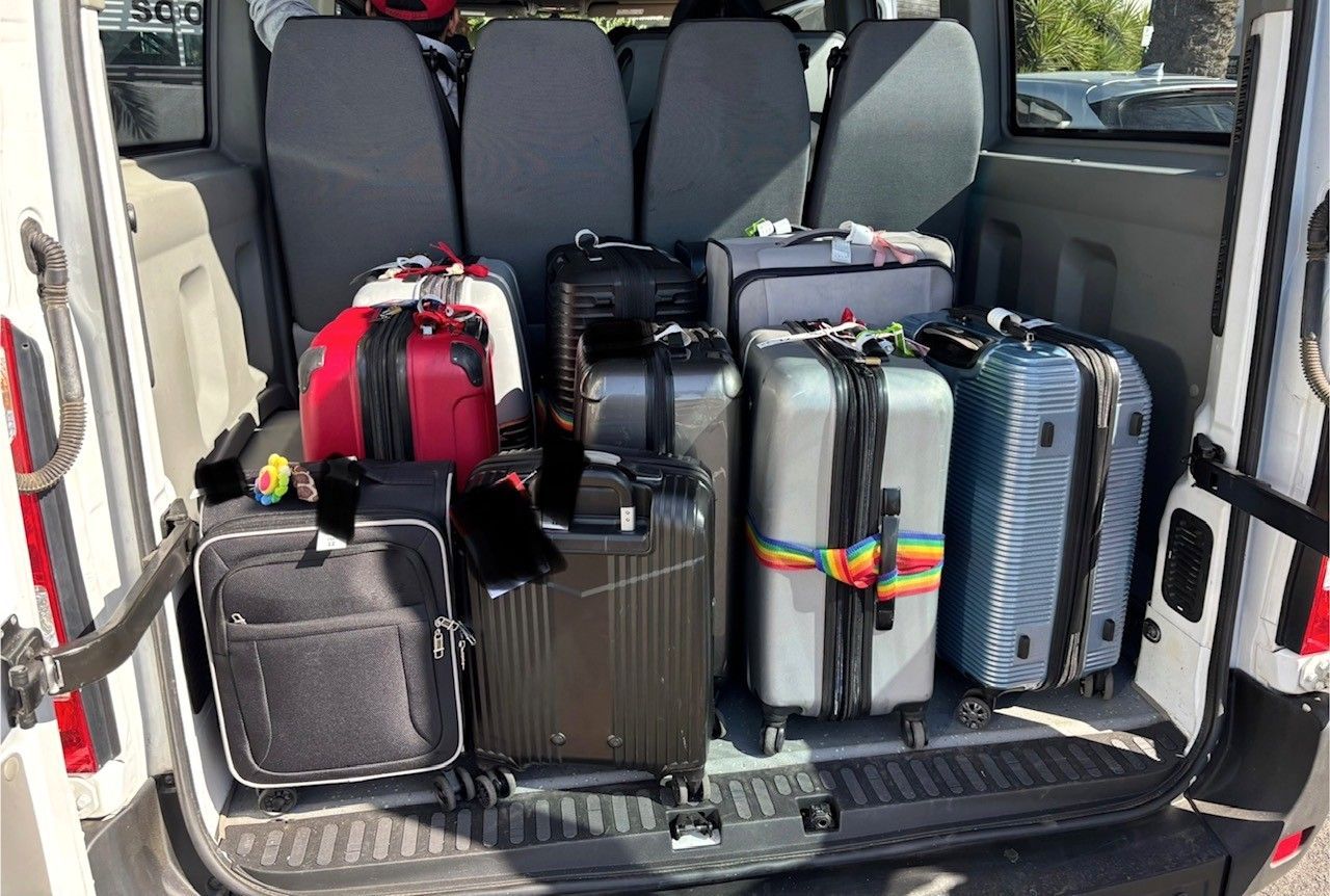 A photo of suitcases and luggage in the rear of the Ticket 2 Ride minibus