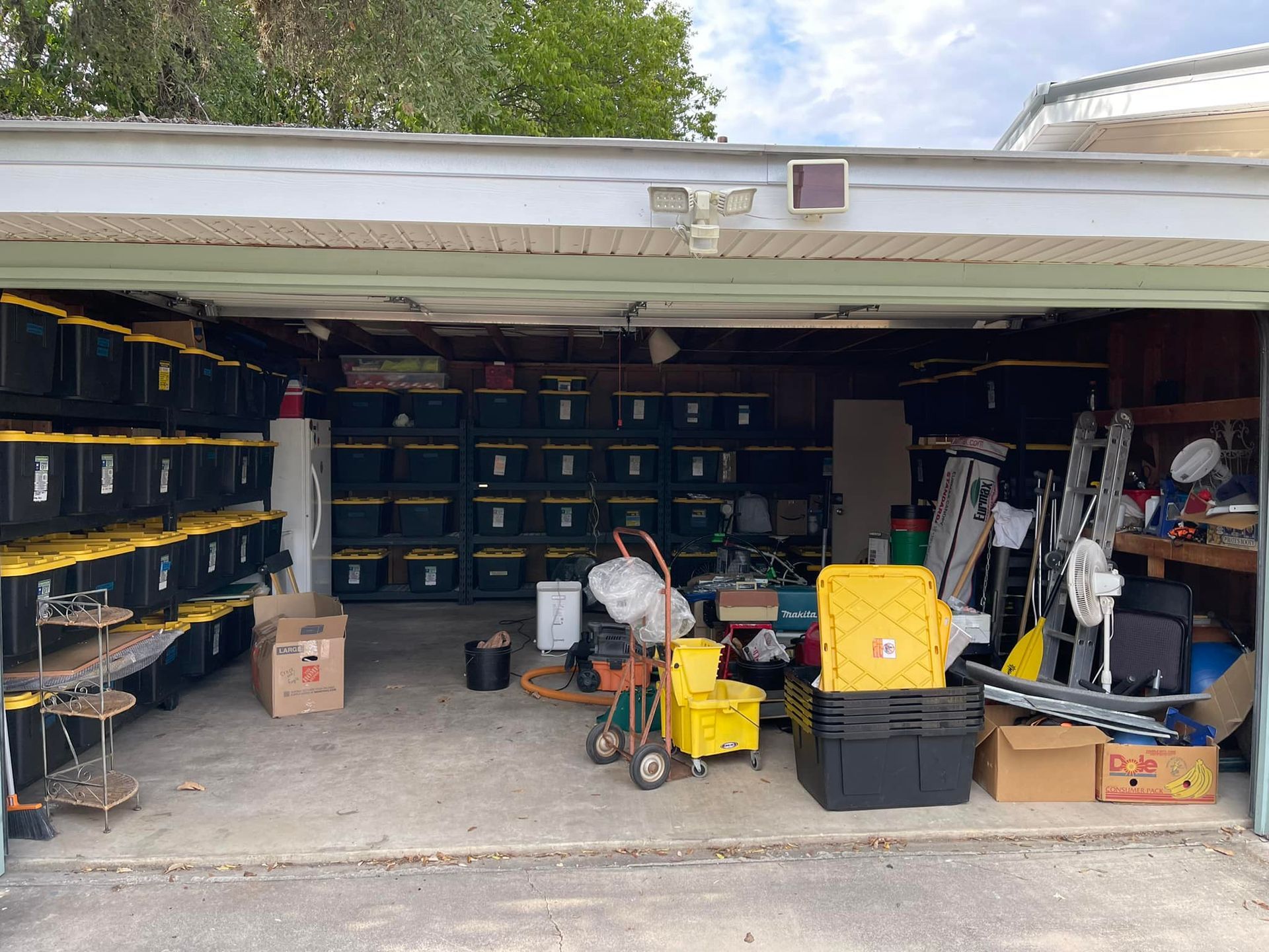 A garage filled with lots of boxes and tools.