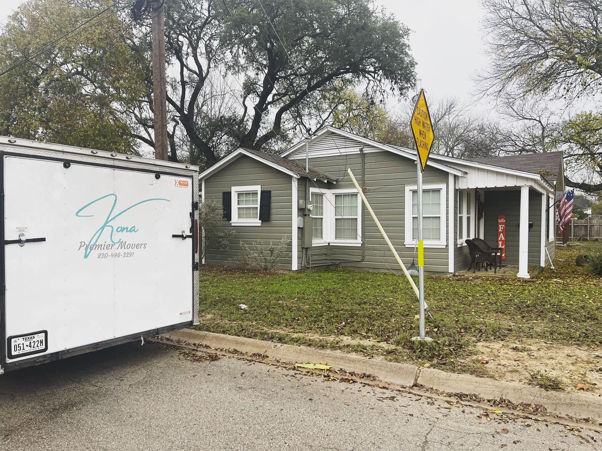 A trailer is parked in front of a house.