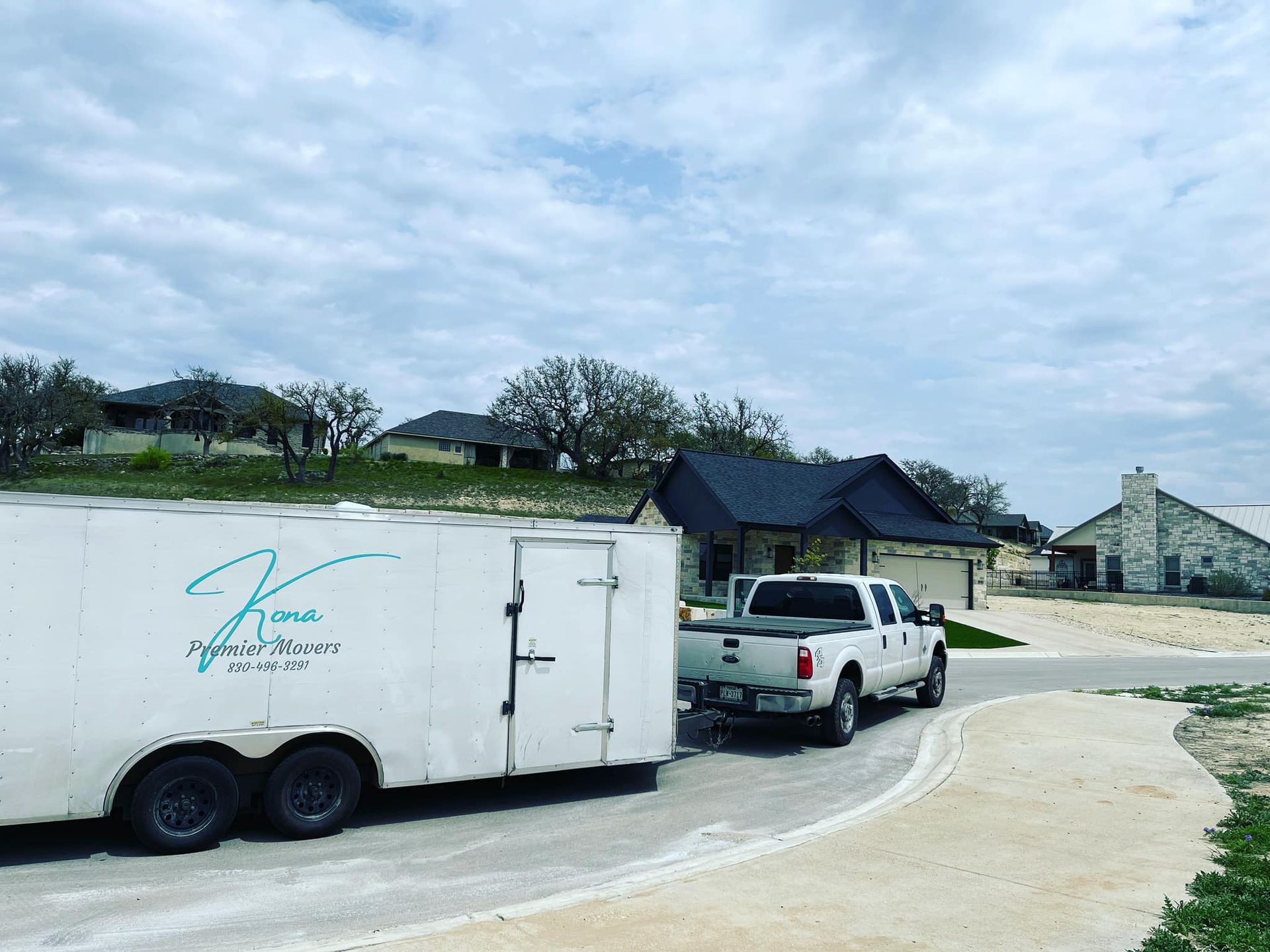 A truck is towing a trailer down a road.