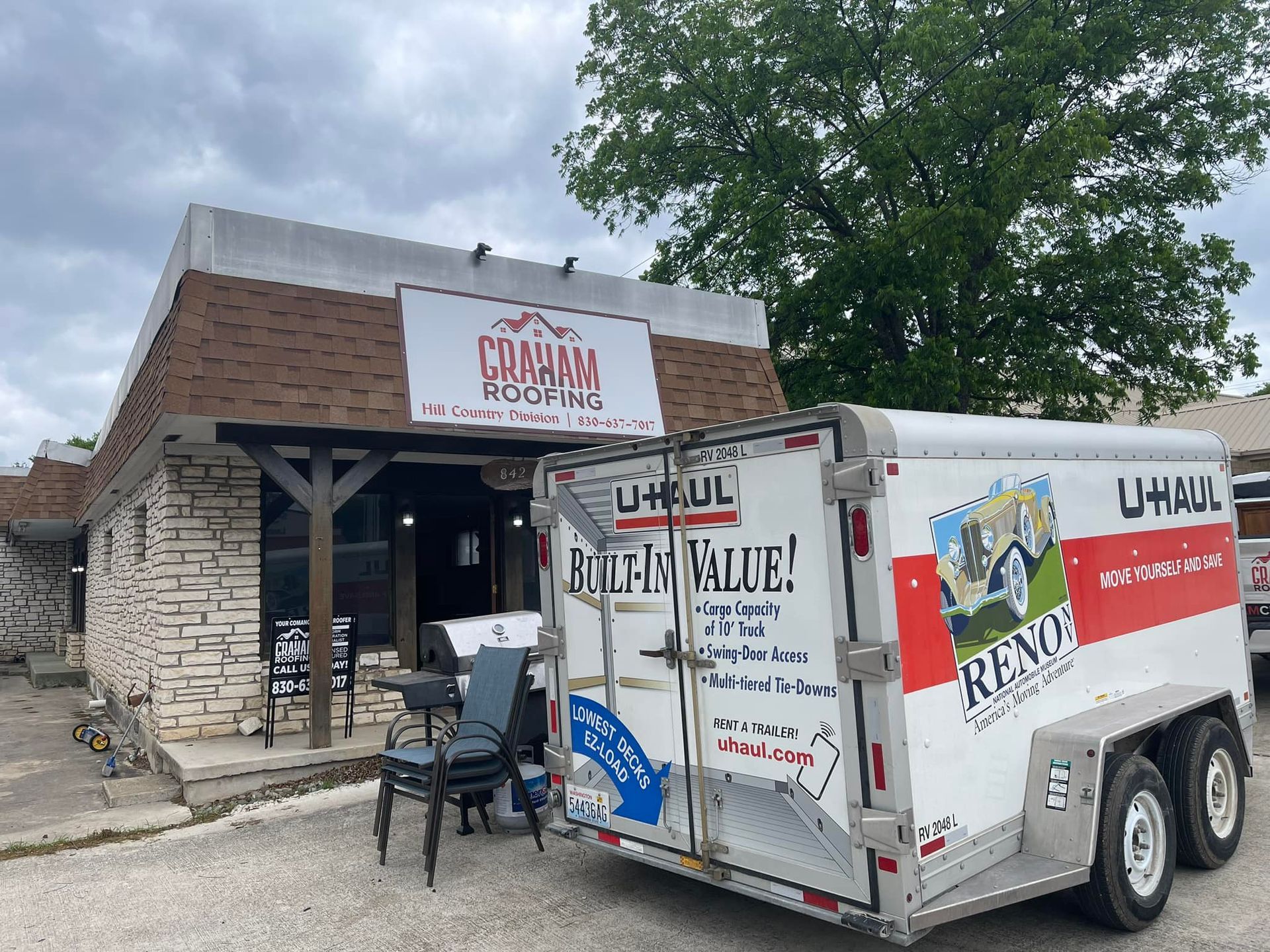 A trailer is parked in front of a building.