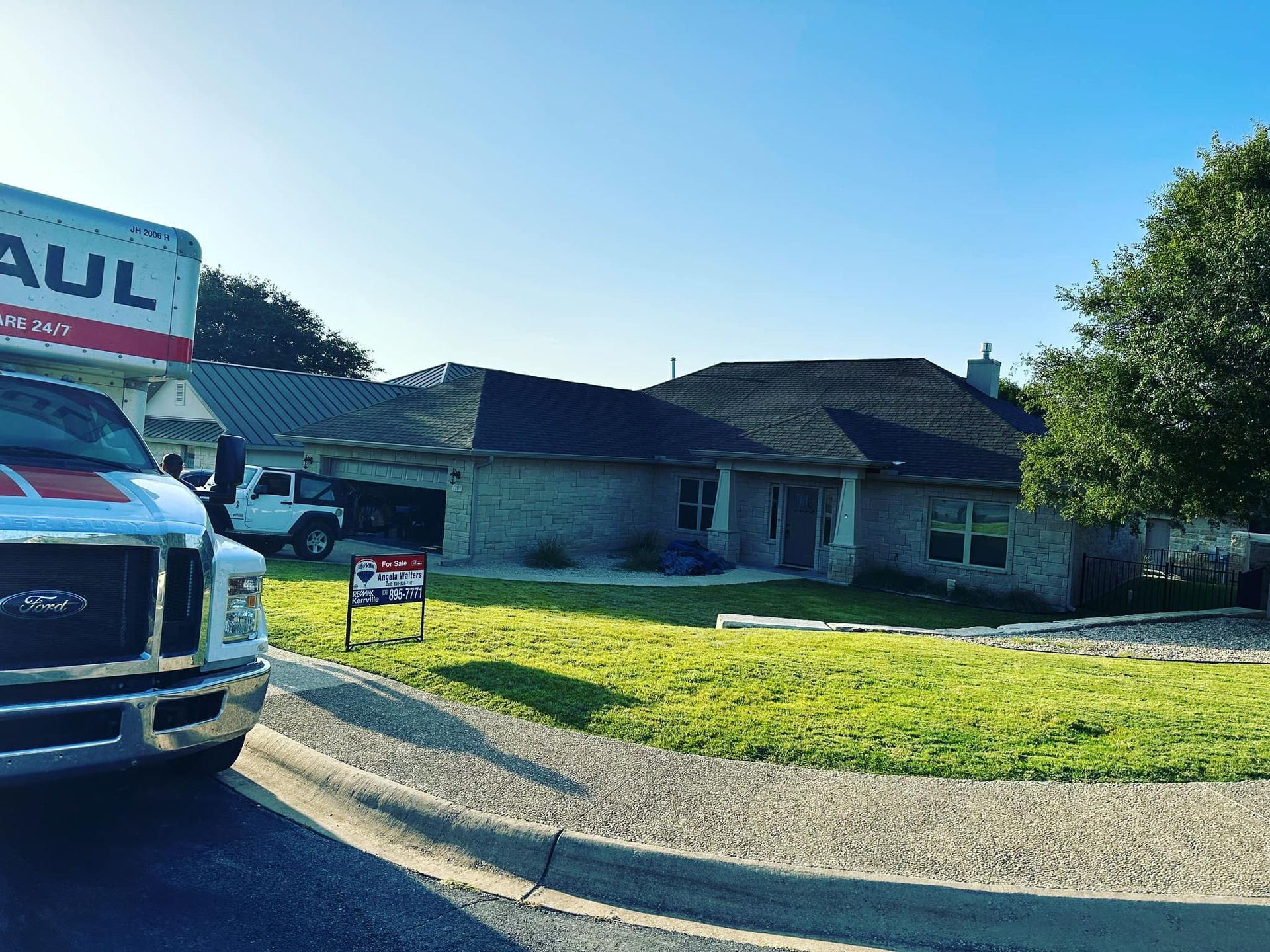 A moving truck is parked in front of a house.