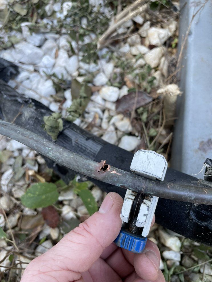 A person is holding a piece of metal in their hand.