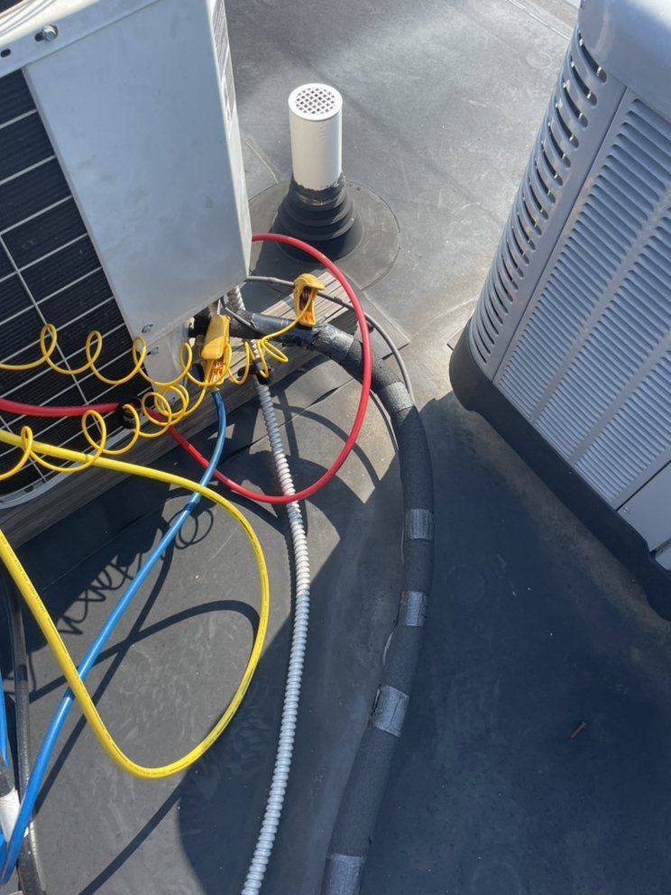 A bunch of wires are connected to an air conditioner