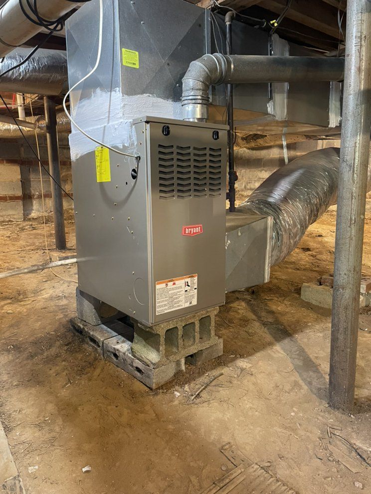 An air conditioner is sitting on top of a concrete block in a basement.