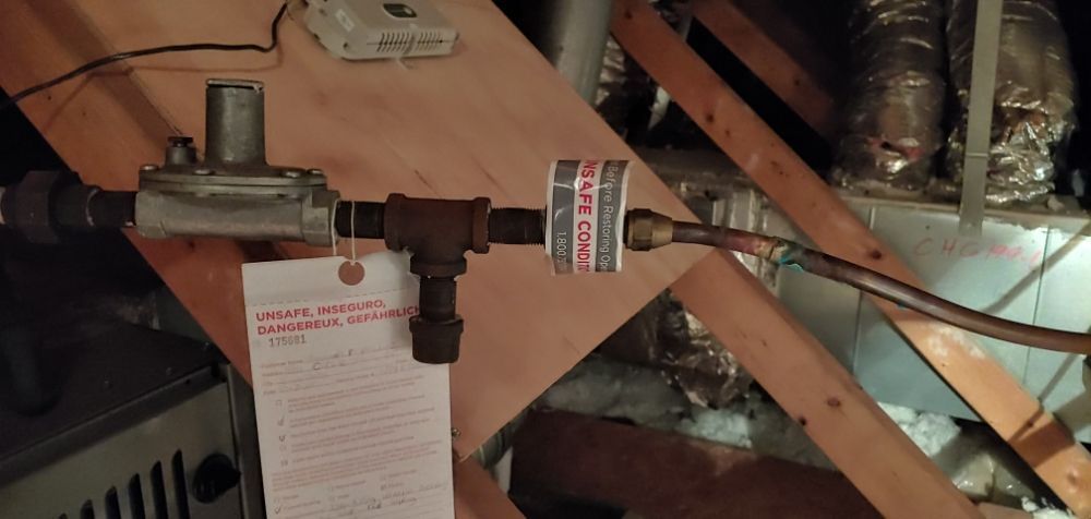 A piece of paper is hanging from a pipe in a room.