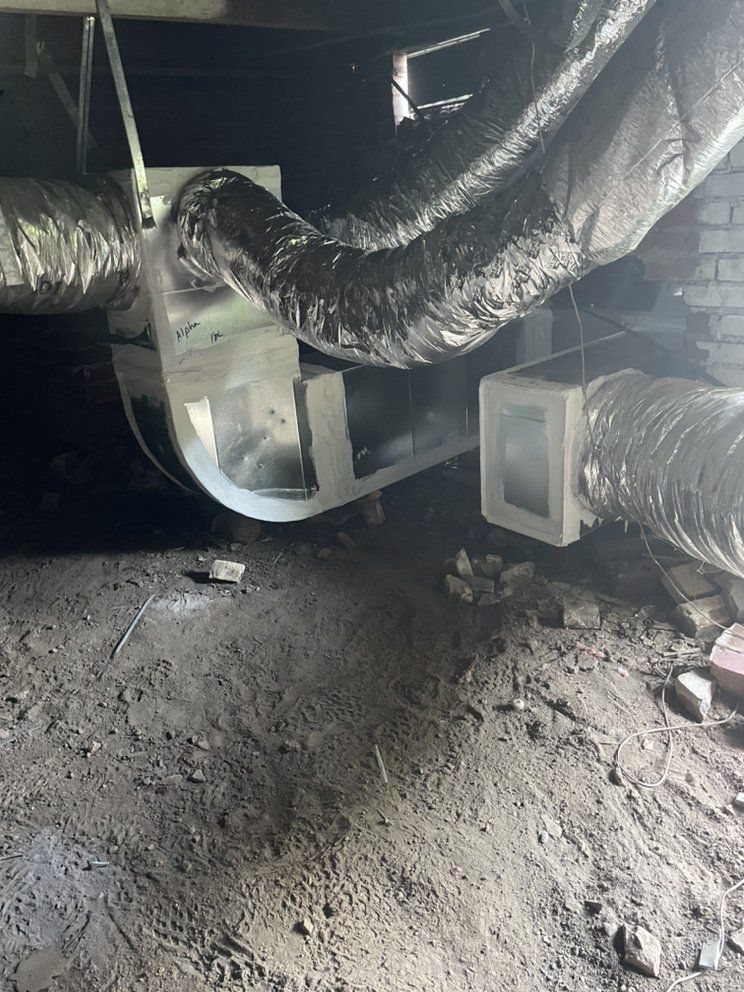 A bunch of pipes are hanging from the ceiling of a room.