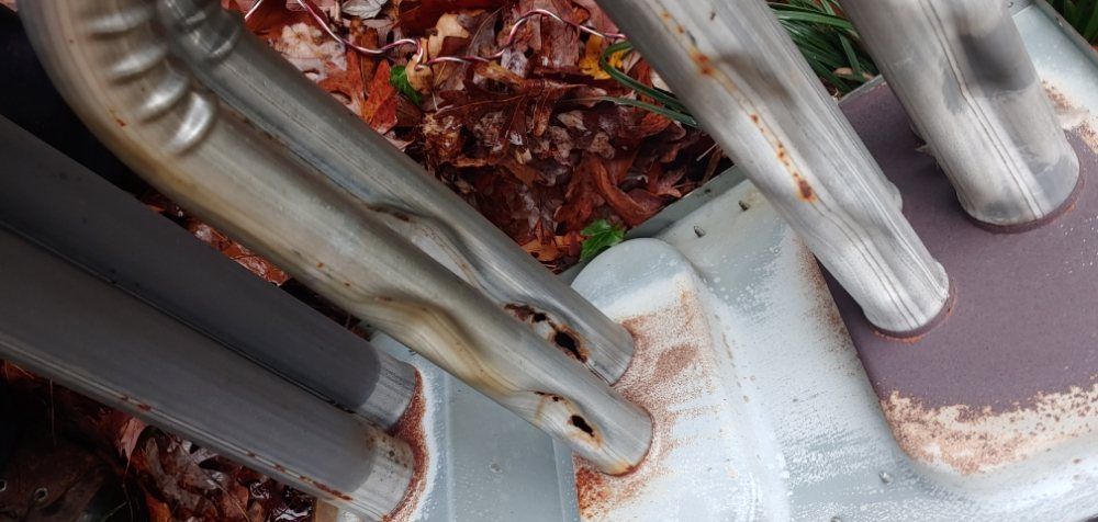 A close up of a metal object with rust on it.