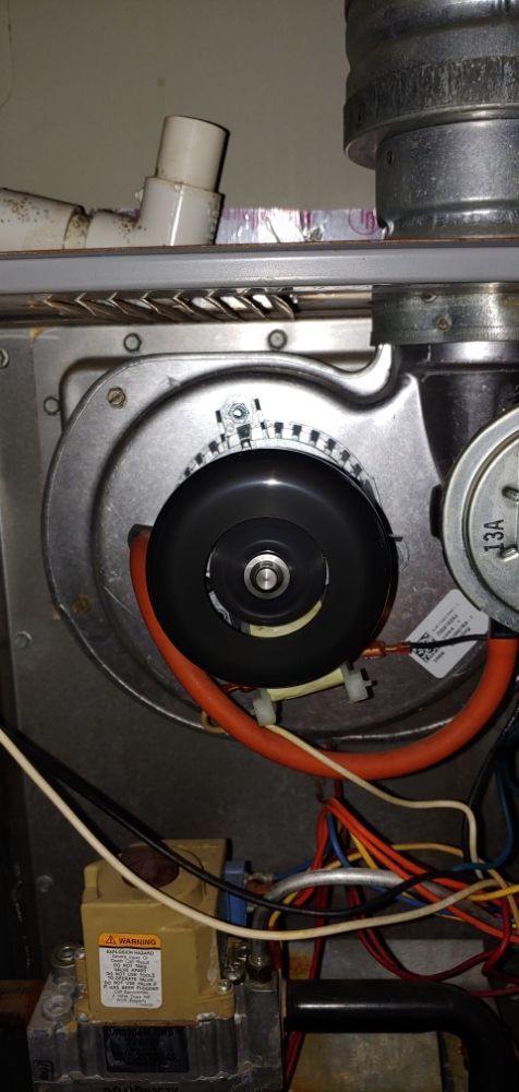 A close up of a fan inside of a heater.