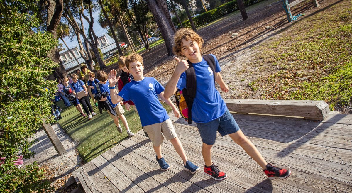 Two young boys are walking down stairs in a park.