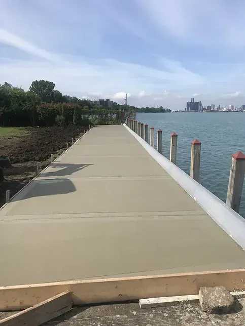 A concrete dock is being built next to a body of water.