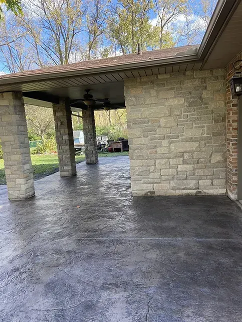 A brick building with a covered patio in front of it.