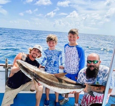 Father and sons on family friendly fishing charter Panama City Beach with Reel Groovy Experiences