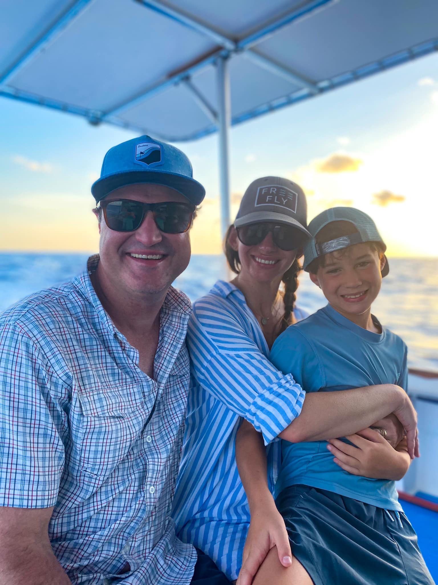 A man , woman and child are on the best sunset cruise in Panama City Beach, Florida with Reel Groovy Experiences.