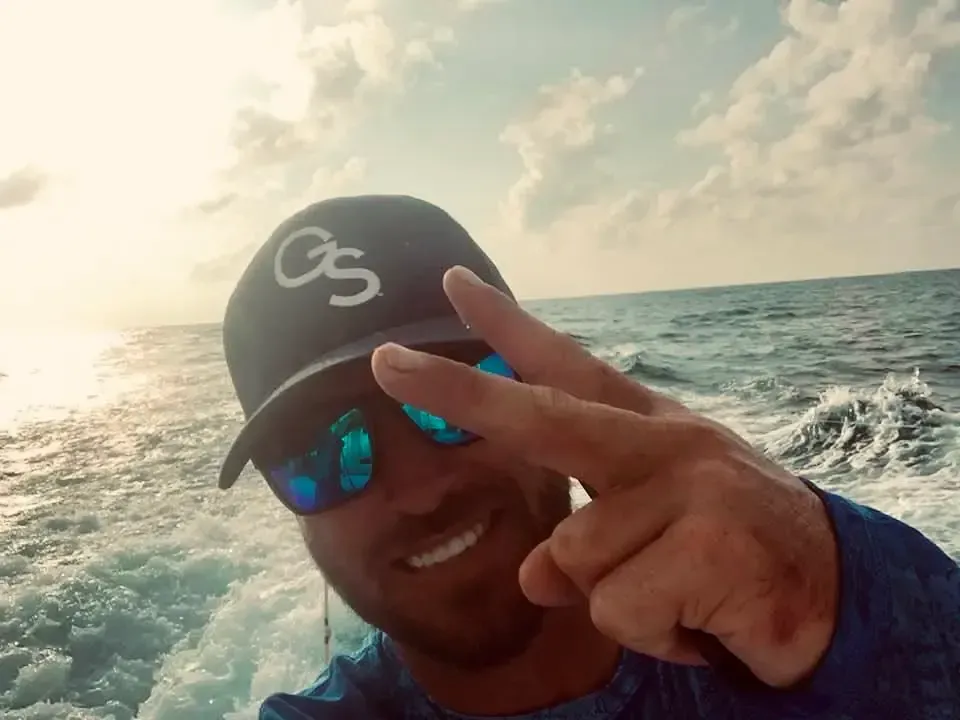 Captain Gary throwing peace sign on fishing charter Panama City Beach with Reel Groovy
