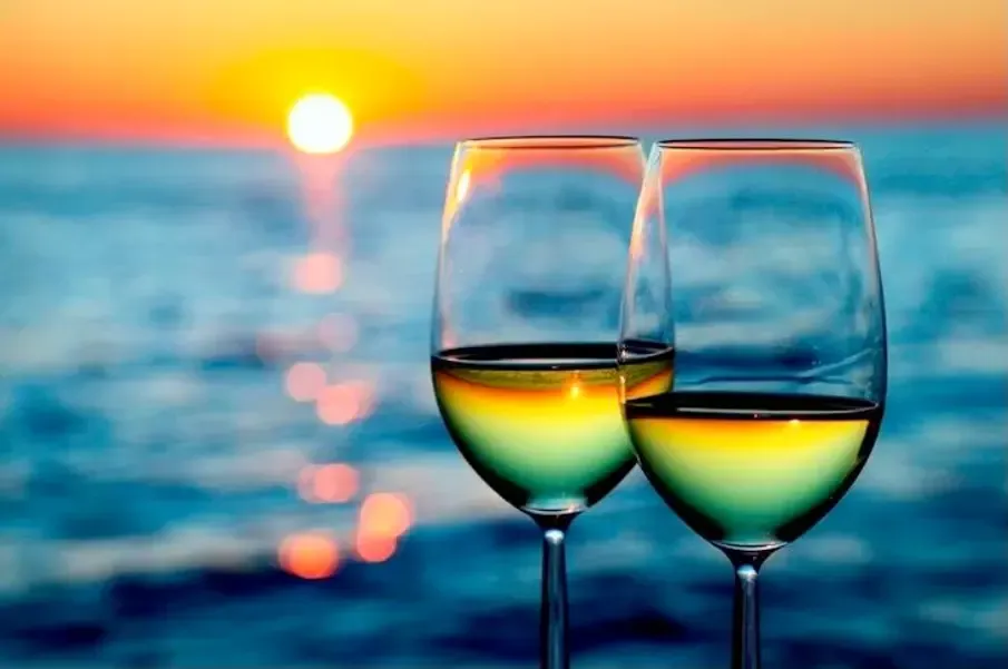 Wine glasses at sunset on Reel Groovy sunset cruise Panama City Beach