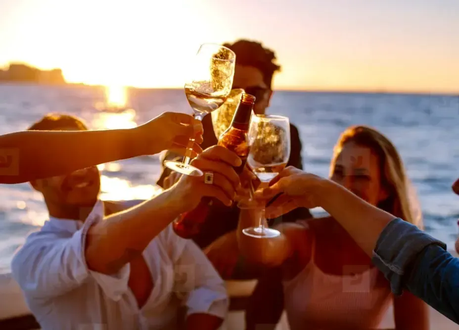 Group toasting with wine glasses on a booze cruise Panama City Beach with Reel Groovy