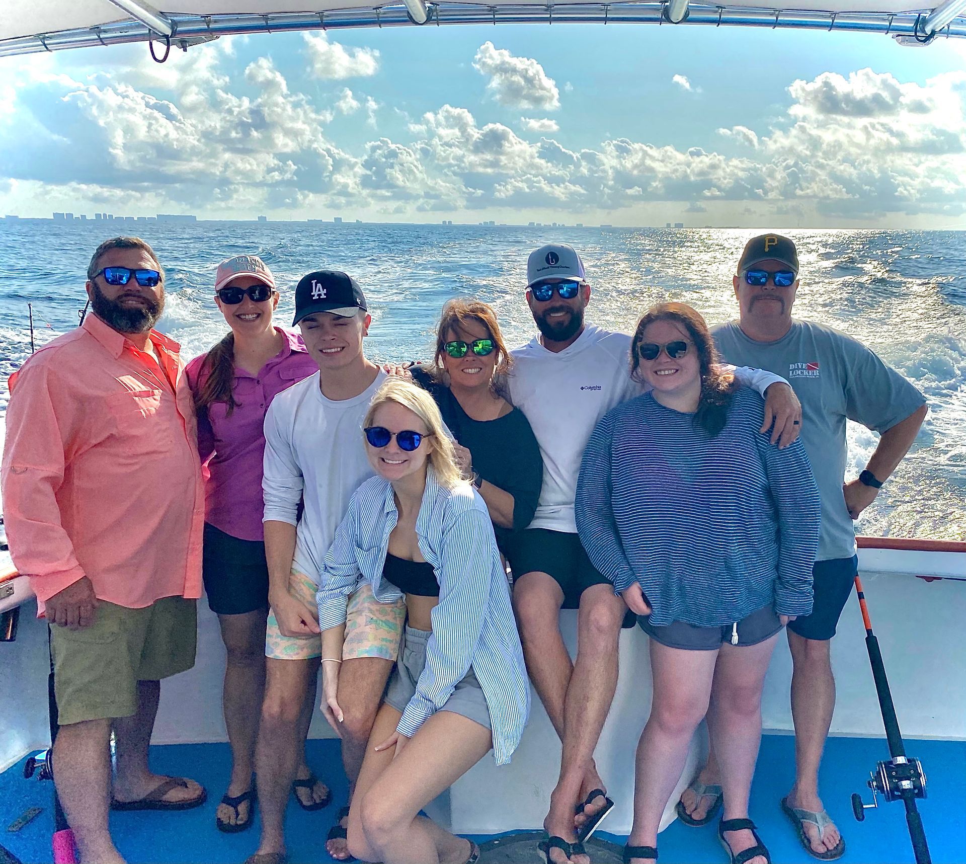 A group of friends are posing for a picture while on a boat tour with Reel Groovy Experiences.