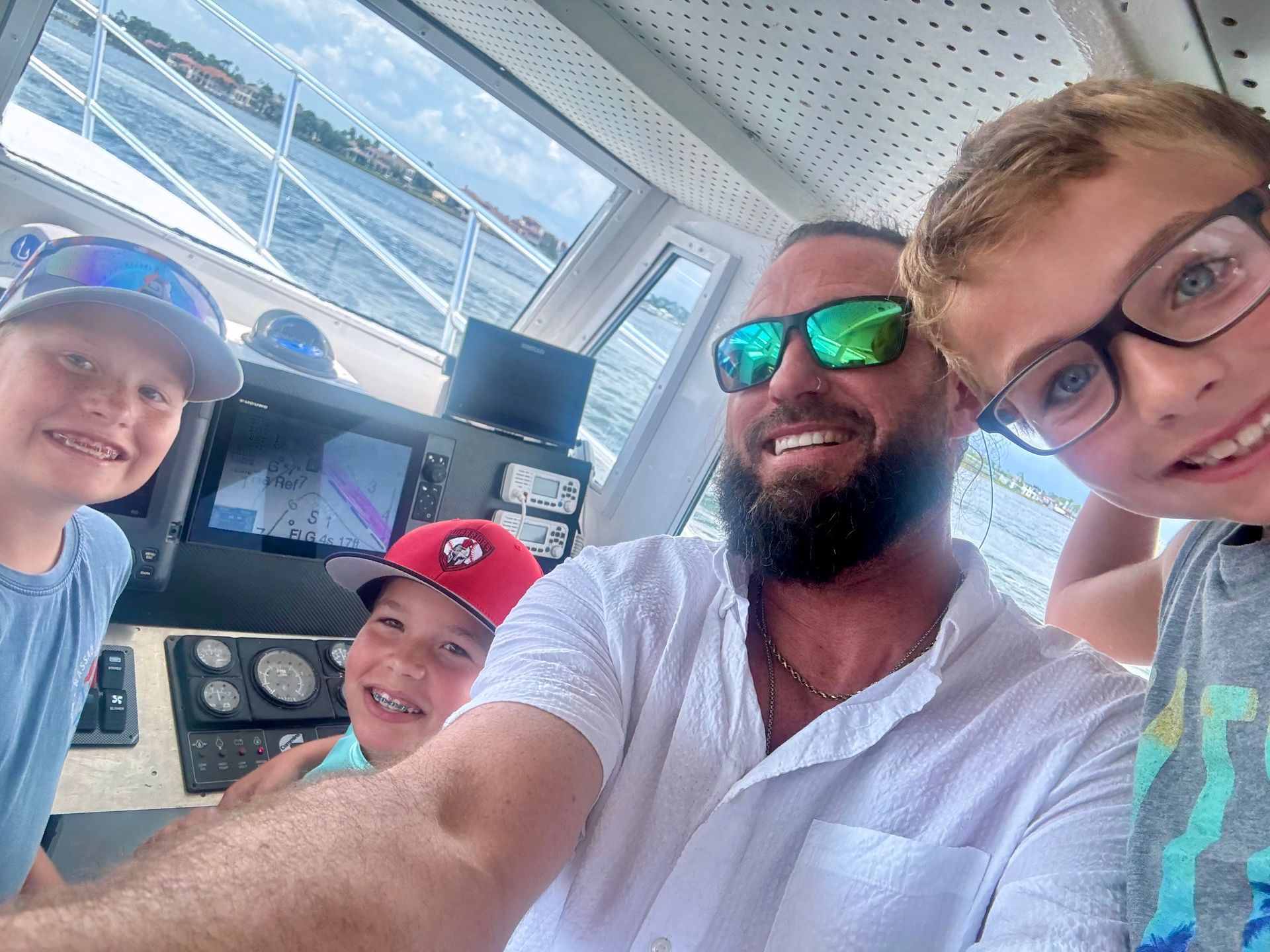 Family-friendly fishing charter Panama City Beach – Captain Gary showing kids the boat
