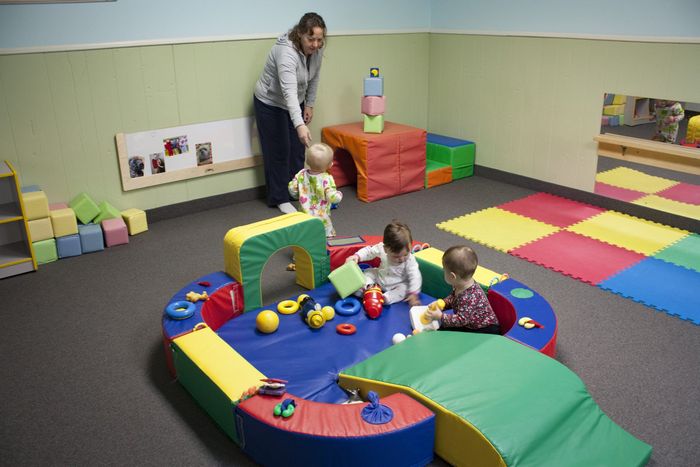 Montessori teacher with infants in infant room at Eden Prairie Montessori in Minnesota