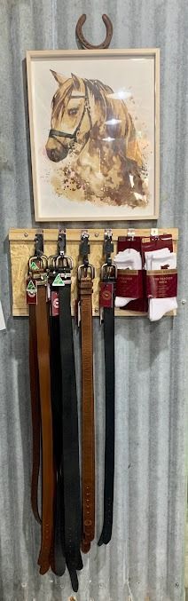 A Picture of A Horse Is Hanging on A Wall Next to A Rack of Belts — Country Charm in Charmhaven, NSW