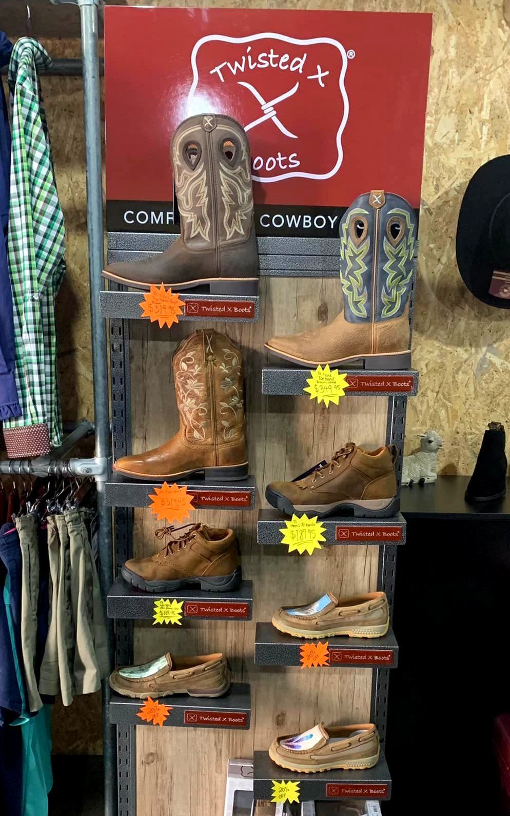 A Black and White Photo of A Display of Cowboy Boots in A Store — Country Charm in Charmhaven, NSW