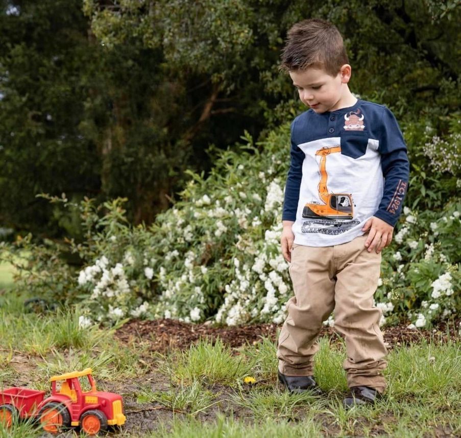 A Pair of Infant Cow Fur Casual Mocs on A White Background — Country Charm in Charmhaven, NSW