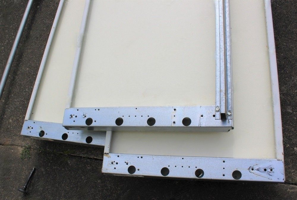 A piece of metal with holes in it is laying on the ground