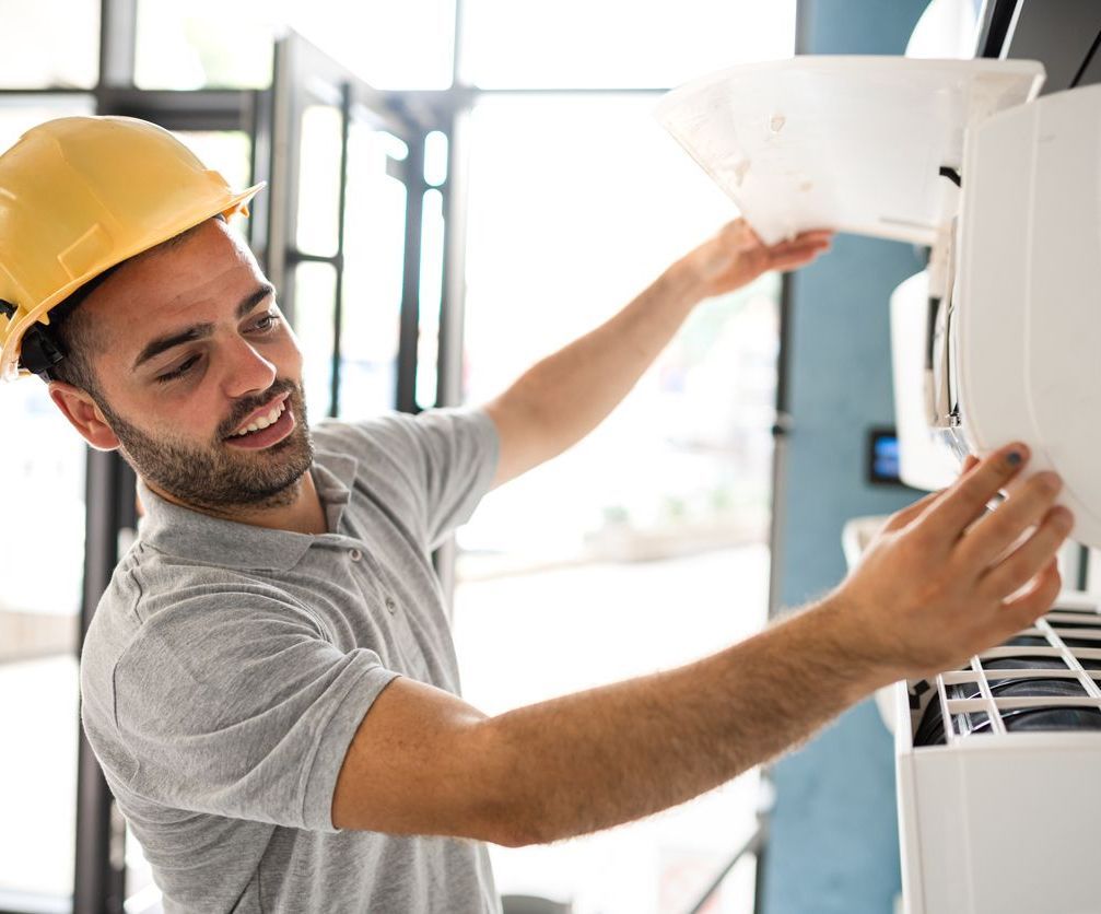 HVAC technician performing repair - Insight Mechanical Service's commercial HVAC repair services in North Georgia