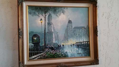 Oil painting of a European city street at night, with streetlights, a monument, and buildings in the rain.