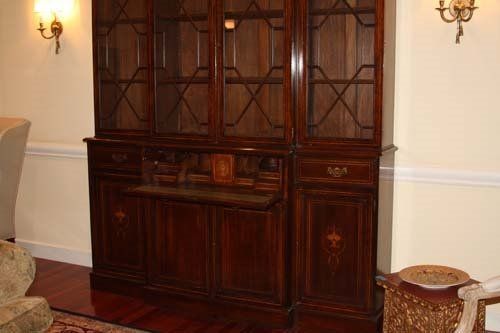 Dark wooden cabinet with glass-doored top, drawers, and lower cabinet doors.