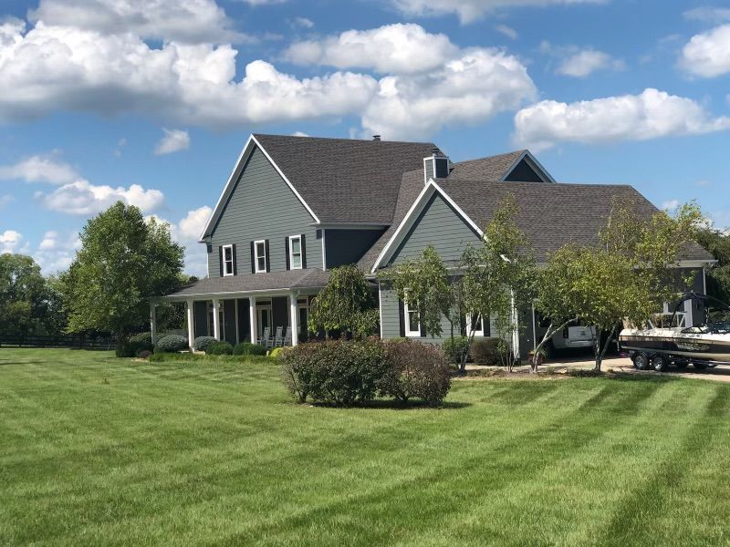 A large house with a large lawn in front of it