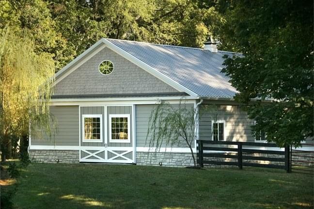 A small house with a fence in front of it