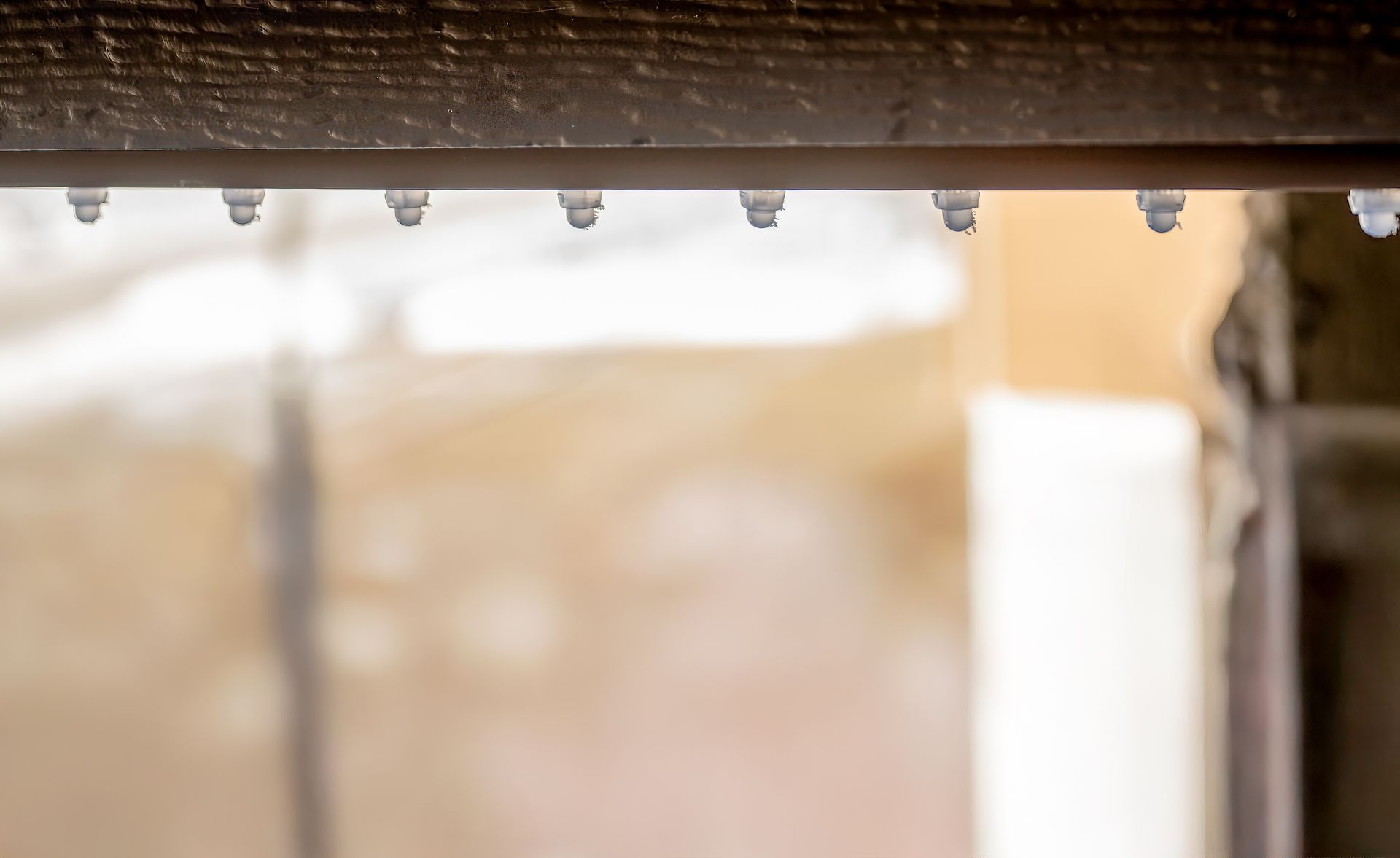 Blurry close-up of a beige fabric surface with a white vertical panel on the right.