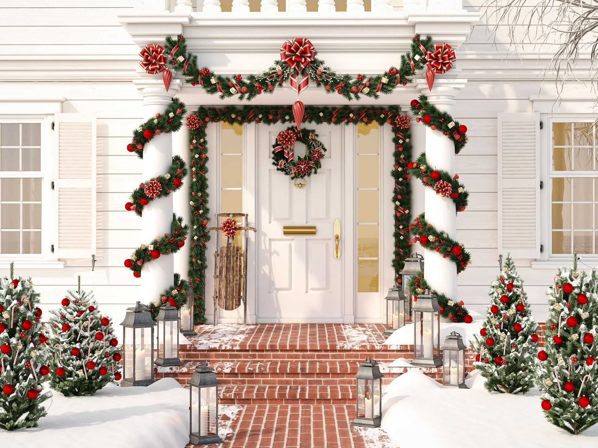 Festive white house entrance decorated for Christmas with garland, wreath, and snow.