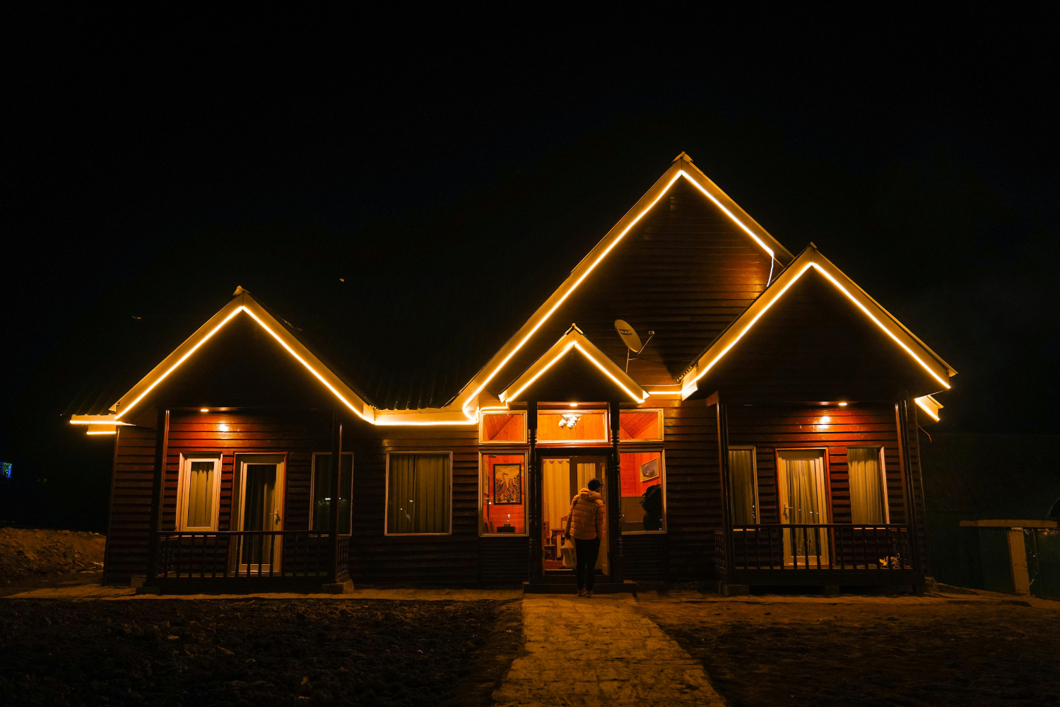 North Fork Dental building with red and green Christmas lights along the roofline at night.