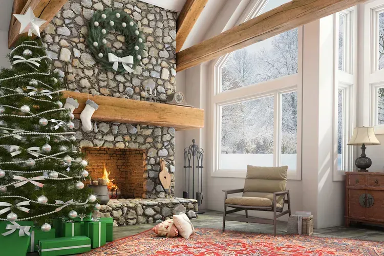 A living room decorated for christmas with a christmas tree and fireplace.