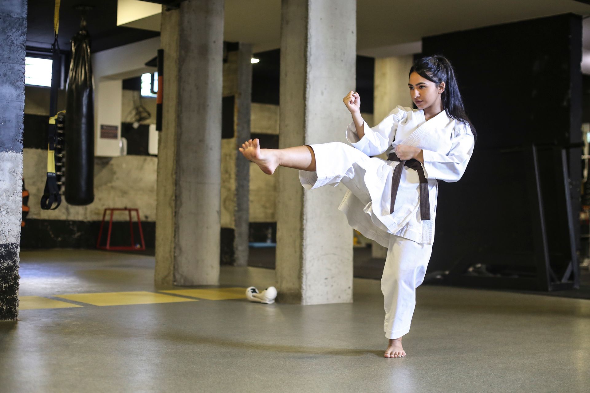 Person practicing Karate high kick in the air - Self Defence Classes In Lalor
